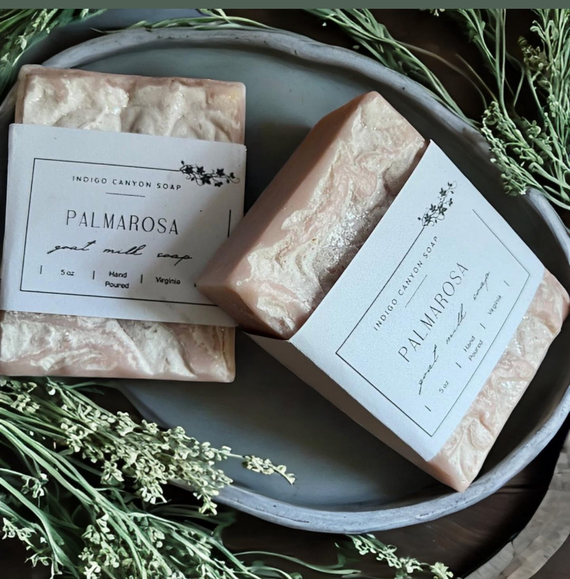 Blush Palmarosa handmade artisan goat milk soap among fresh herbs