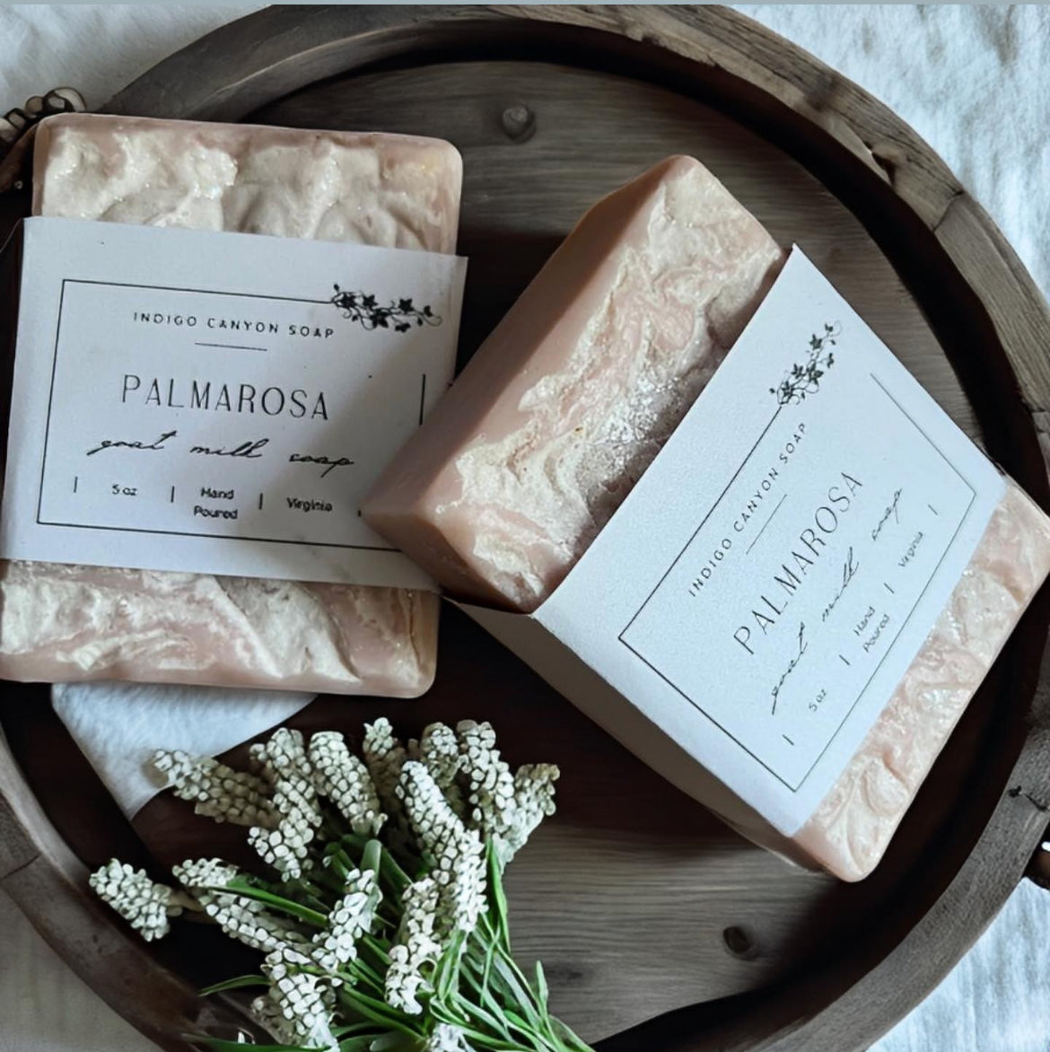 Blush Palmarosa homemade natural goat milk soap sitting on a plate