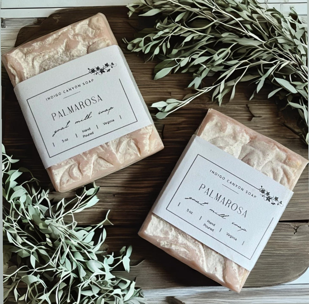 Blush Palmarosa natural soap bars scattered on a wooden table